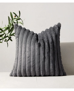 Close-up of deep gray plush pillow case featuring a ribbed texture on a soft sofa