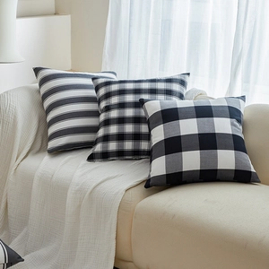 Minimalist black and white plaid decorative pillows on a sofa with cozy Nordic style