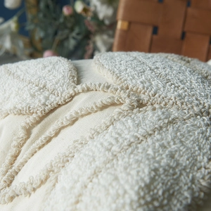 Minimalist cream tufted leaf pattern pillow cover with textured boucle fabric surface