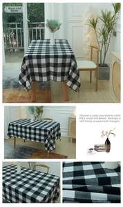 Detail of black and white checkered tablecloth fabric texture on rectangular wooden table
