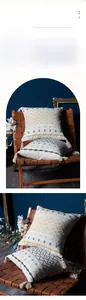 Detailed embroidery of geometric patterns and corner tassels on a woven cotton cushion cover