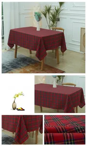 Detailed view of red and green tartan plaid tablecloth fabric on a wooden table