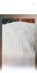 Macro detail of off-white jacquard canvas cushion cover with textured geometric weave