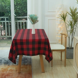 Classic red and black checkered tablecloth on a wooden table for home dining decor