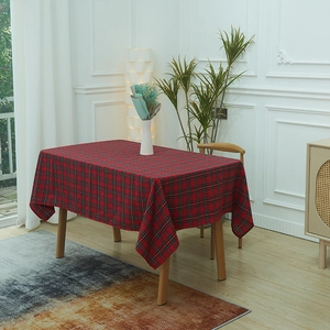 Classic red and black plaid tablecloth on a wooden dining table in a cozy home setting