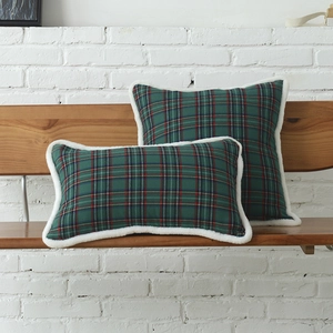 Christmas green plaid decorative pillow covers with cozy white faux fur trim on wood bench