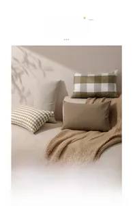 Detailed view of woven fabric textures for plaid and striped decorative pillow covers