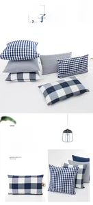 Detail of navy blue and white plaid cushion cover featuring invisible zipper and soft texture