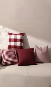Detail of red checkered cushion covers in woven polyester on a living room sofa