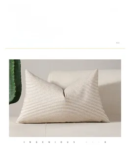 Detail of minimalist beige striped cushion cover on a sofa with cozy home decor