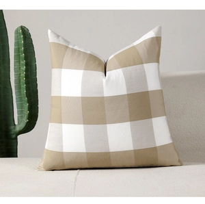 Close-up of khaki gingham plaid square cushion cover on sofa with rustic linen texture