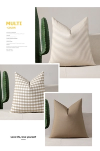 Detailed view of beige checkered and striped pillow covers on a minimalist sofa