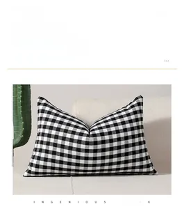Modern rectangular black and white gingham checkered pillow cover on a minimalist sofa