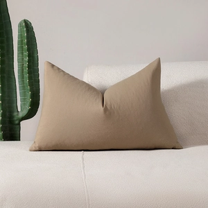 Minimalist khaki checkered cushion cover on white sofa with green cactus decoration
