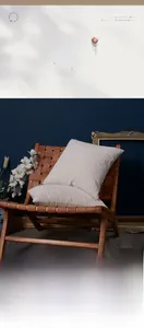Close-up of cream chenille cushion with 3D wave texture on a brown wooden chair