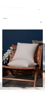 Detail of chenille cushion with 3D leaf pattern on a premium leather woven chair