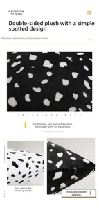 Detail of plush black and white spotted cushion cover with hidden zipper and overlocked edges
