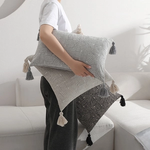 Minimalist geometric jacquard throw pillow covers with tassels on a white sofa