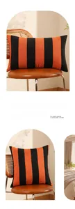Detail of modern orange and black striped decorative pillow covers with textured fabric