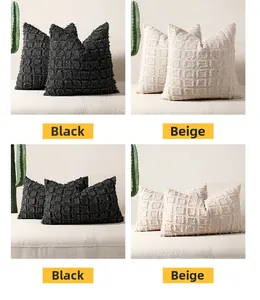 Detail of tufted plaid patterns and fringed edges on black and beige cushion covers