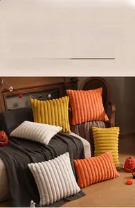 Macro detail of plush striped textures on orange and cream festive throw pillows