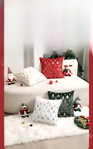 Detail of Christmas pillow covers featuring gold sequined trees on plush velvet fabric