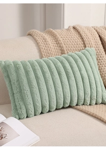 Detailed texture of light green plush pillow with vertical stripe pattern on sofa