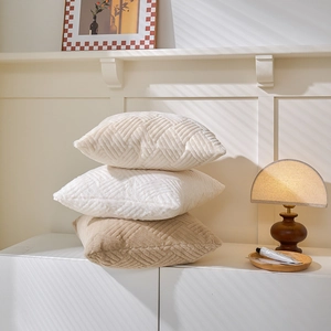 Plush throw pillow covers with geometric V-shaped embossing in cream and light brown