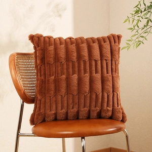 Faux rabbit fur throw pillow with wheat spike texture on a vintage chair