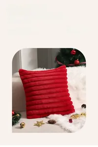 Close-up of red Christmas plush pillow cover with soft striped faux fur texture