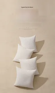 Macro detail of cream chenille jacquard pillow cover with 3D embossed geometric texture