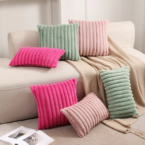 Plush faux rabbit fur pillow covers with wide stripe texture on a cozy home sofa