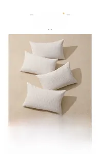 Detail of cream chenille cushion covers with 3D geometric jacquard relief and knit textures