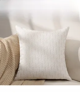 Detail of cream chenille cushion cover featuring 3D geometric jacquard texture on sofa