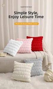 Pile of plush heart quilted cushion covers in multiple colors on a soft sofa