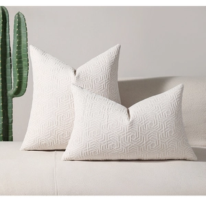 Detail of cream chenille throw pillow with 3D embossed geometric jacquard pattern texture