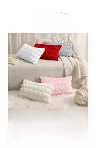 Close-up of plush heart pattern pillow covers in assorted colors on a cozy sofa
