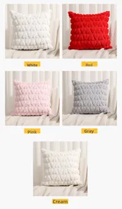 Detail of 3D heart embossed plush pillow covers in white, red, pink, grey and cream