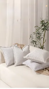 Close-up of modern striped cotton-polyester pillow covers with unique frayed edge details
