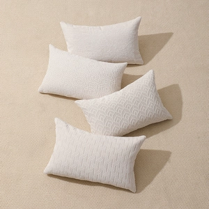Set of four cream chenille jacquard pillow covers with 3D embossed geometric textures