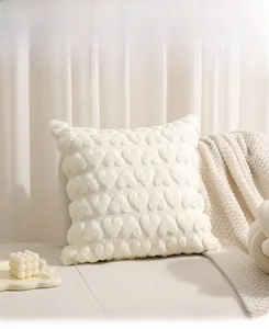 Close-up of cream white plush pillow cover with 3D tufted heart texture and soft fabric
