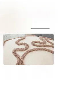 Detail of beige sherpa pillowcase featuring textured dark brown tufted wave patterns