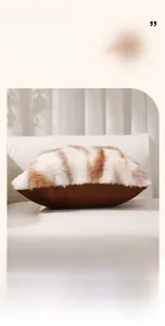 Detail of faux fur plush pillow case with brown tiger stripe texture on white sofa