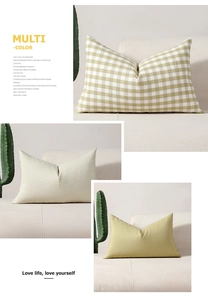 Detailed texture of green checkered and striped decorative sofa pillows on a soft couch