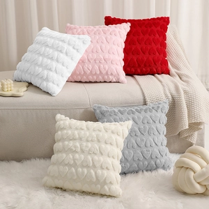Plush square pillow covers with 3D embossed hearts in white, pink, red, and grey colors