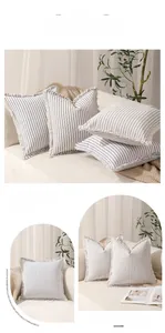 Detail of modern striped pillowcase with hand-crafted fringe edge and soft fabric texture