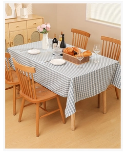 Detailed texture of blue and white gingham waterproof tablecloth on a wooden table