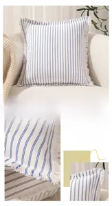 Detail of blue and white striped cotton-linen pillow cover with fringe trim