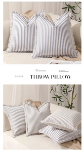 Close-up of blue and white striped throw pillow cover with decorative fringed edges