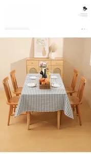 Detailed close-up of blue and white checkered tablecloth with natural linen texture